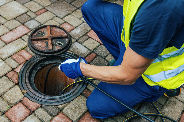 image showing a man performing hydrojetting.